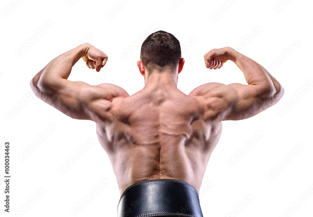 Muscular man in studio over dark background show his delt and back