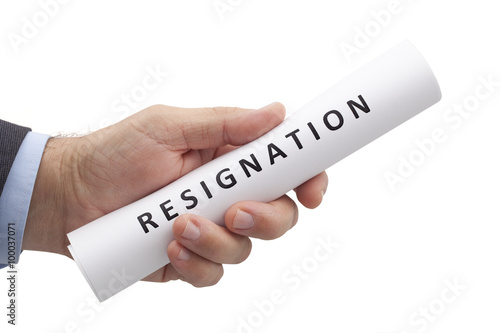 Man in a suit gives a rolled letter of resignation isolated on white background. Image with clipping path.