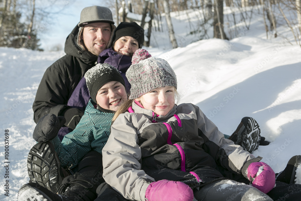 parents and daughters sledding at winter time parents and daughters sledding at winter time