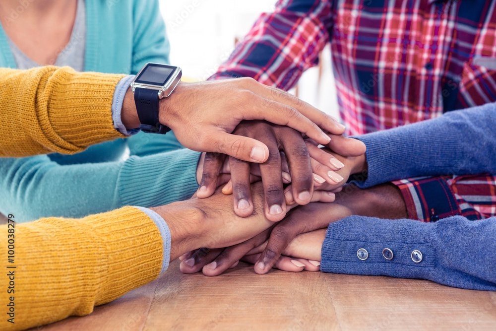 Business team stacking hands on desk Business team stacking hands on desk