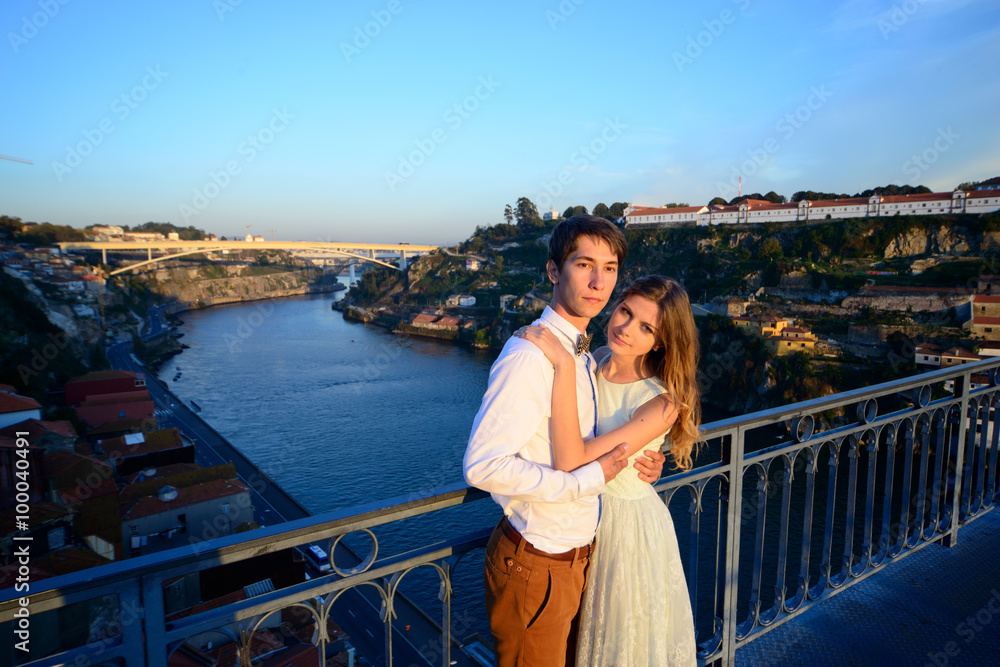 Happy young couple stands on background Porto