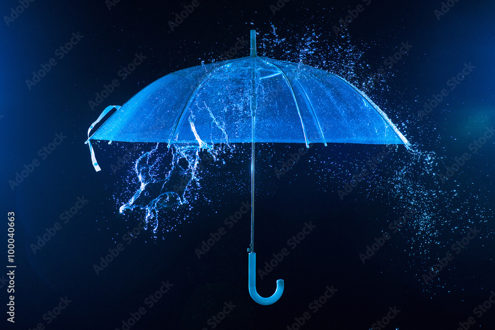 Rain drops falling on an umbrella