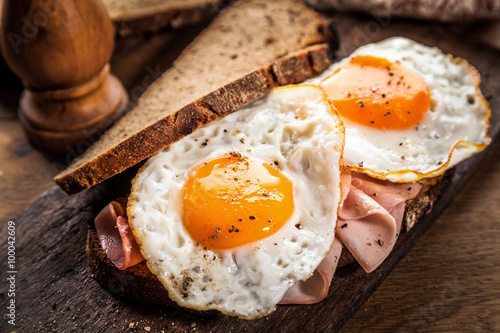 Fried eggs and ham for breakfast photo
