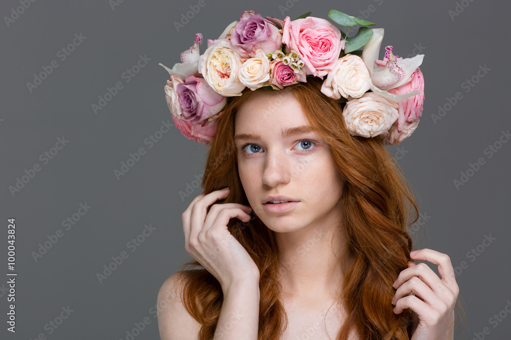 Charming sensual young redhead woman in rose wreath
