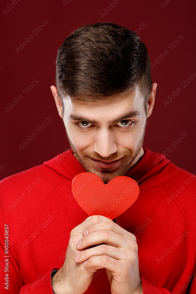 Valentine's Day concept. Man holding a red heart Valentine's Day concept. Man holding a red heart