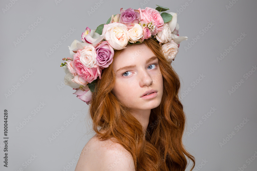 Beautiful tender woman with long hair in wreath of flowers