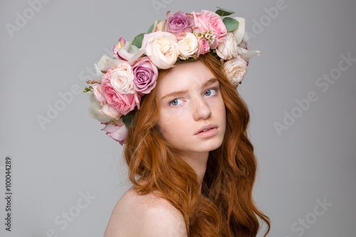 Beautiful tender woman with long hair in wreath of flowers