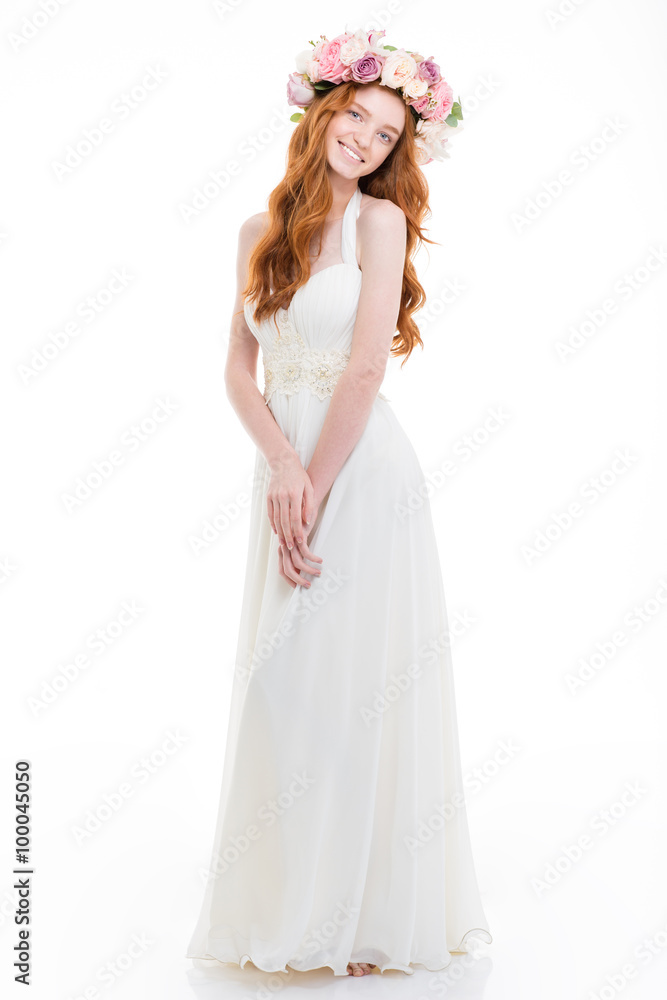 Smiling redhead woman with wreath from flowers Smiling redhead woman with wreath from flowers