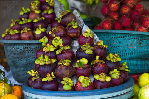 Fresh exotic tropical fruits for sale at an outdoor market.