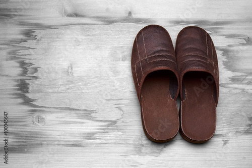 Men's brown boots on a wooden floor
