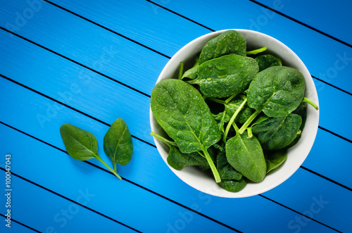 Fresh spinach in white bowl