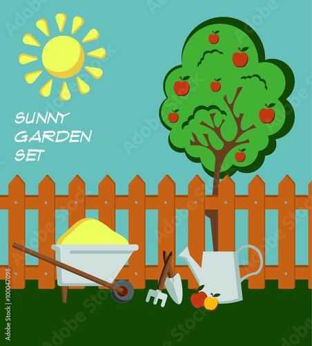 Summer time garden flat style composition with a brown fence, metal watering can, an apple tree with red fruits, garden tools and a wheelbarrow with yellow sand; bright sun, blue sky and green grass.