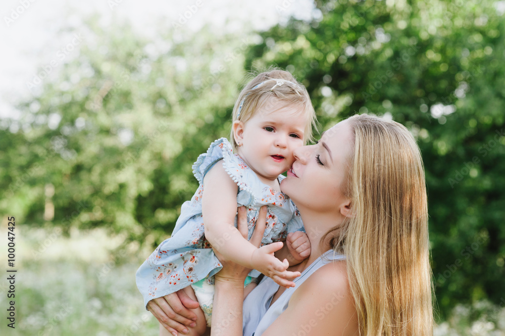Young mother playing with her little daughter on the nature, motherhood, tenderness, childhood, tenderness, lifestyle