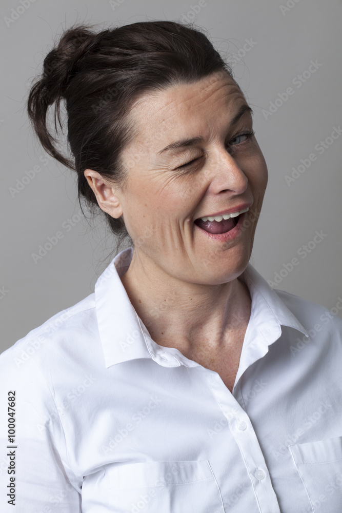 mature flirting concept - pretty 40s woman winking for fun and seduction with serenity, studio shot mature flirting concept - pretty 40s woman winking for fun and seduction with serenity, studio shot