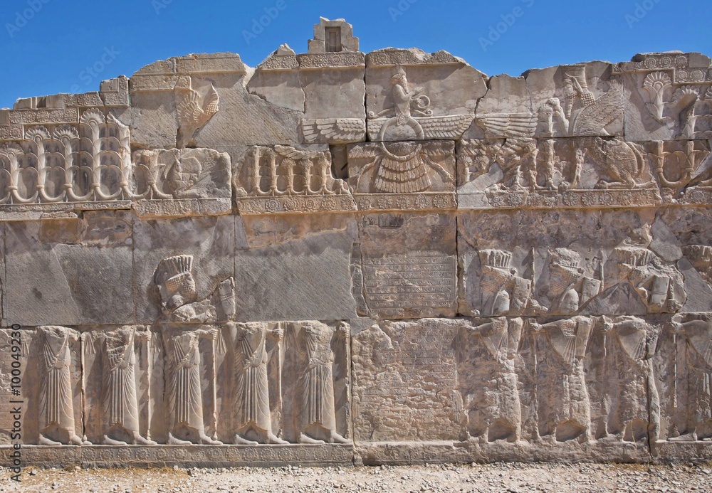 Scene with Faravahar - relief of winged sun symbol of Zoroastrianism in ruined Persepolis