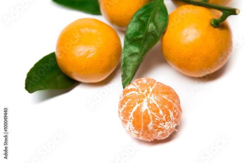 Fresh orange mandarine with leaf isolated on white background