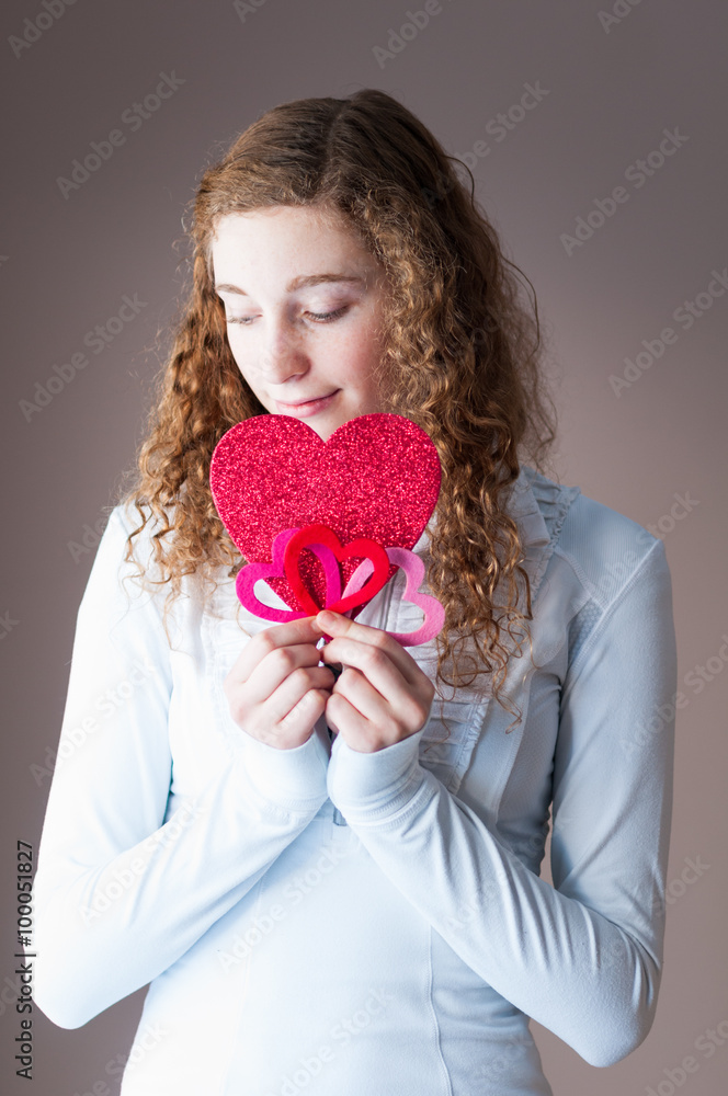 cute teengage girl holding out a bunch of valentine hearts cute teengage girl holding out a bunch of valentine hearts
