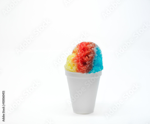 Hawaiian Rainbow shaved ice, shave ice, or snow cone in a white cup with a white background.