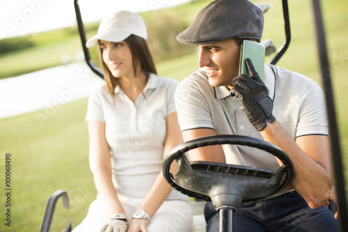 Young couple at golf cart