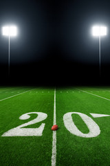 Football field illuminated by stadium lights