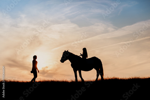 silhouette of girl and horse lesson riding