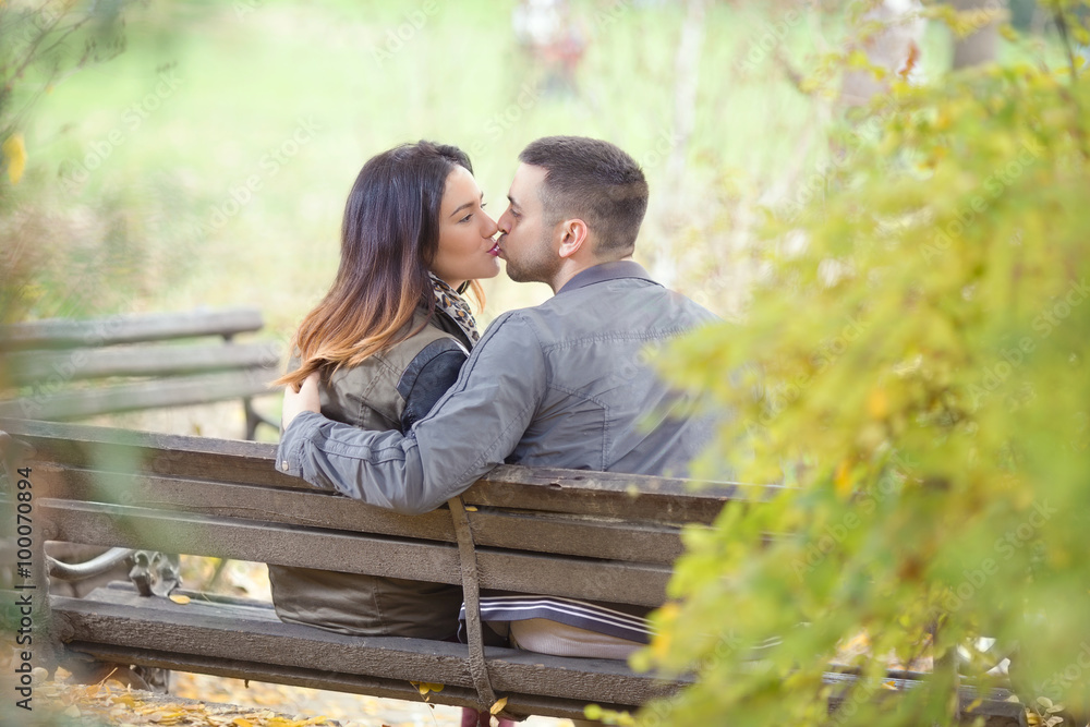 Affectionate young couple kissing in a park Affectionate young couple kissing in a park
