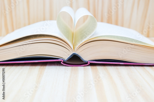 open book and forming a heart with their central leaves
