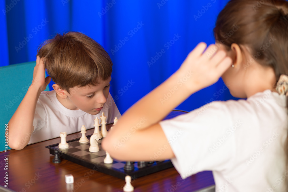 Children play a board game called chess. Children play a board game called chess.