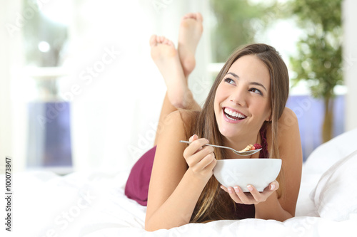 Healthy girl eating cereals at breakfast