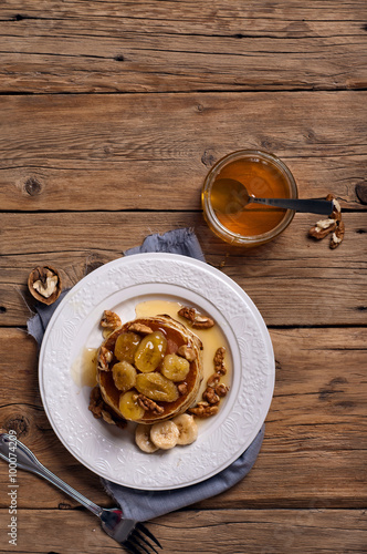 Golden pancake with caramelized bananas, honey and nuts