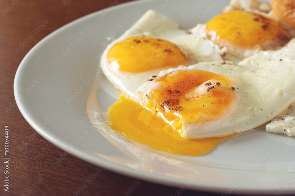 fried eggs closeup on a white plate fried eggs closeup on a white plate