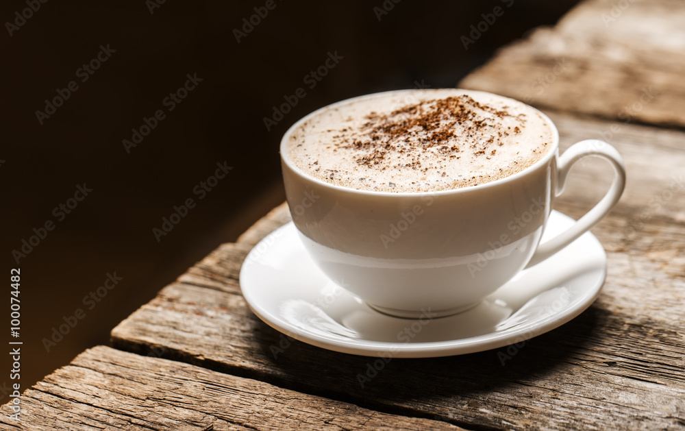 Close-up of coffee cup on wooden background. Close-up of coffee cup on wooden background.