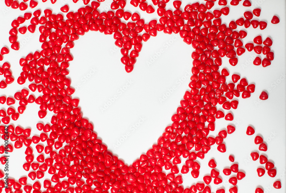 cinnamon heart candy poured out on to a painter's art canvas in the shape of a heart cinnamon heart candy poured out on to a painter's art canvas in the shape of a heart
