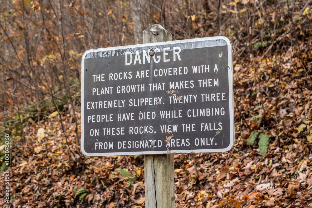 Danger sign at Crabtree Falls in the George Washington Forest in Nelson County, Virginia, near the Blue Ridge Parkway in the autumn season.