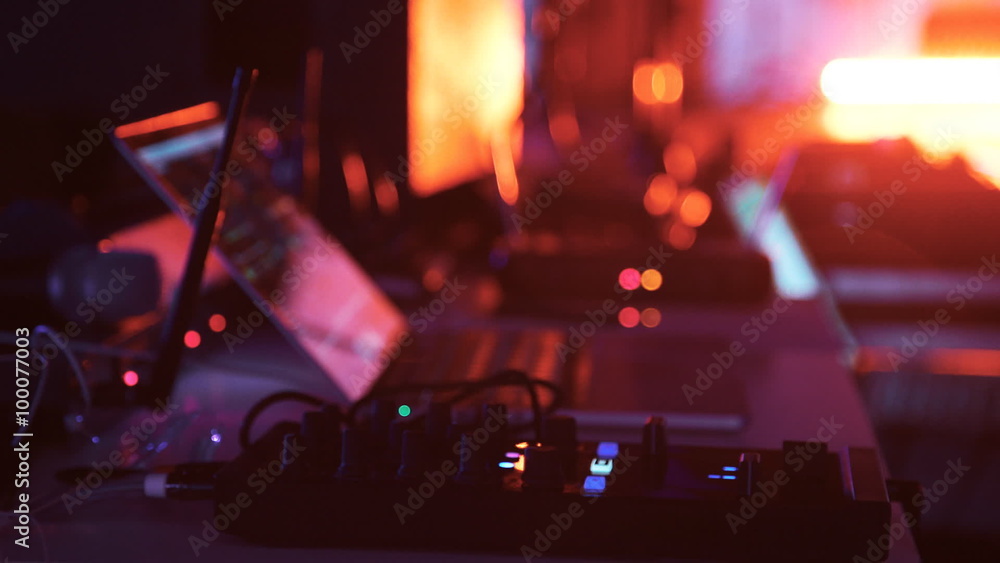  DJ works with Laptop. Red light on background 1