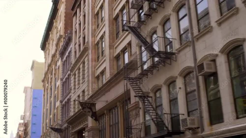 Tracking shot of the side of buildings with fire escapes. Tracking shot of the side of buildings with fire escapes.