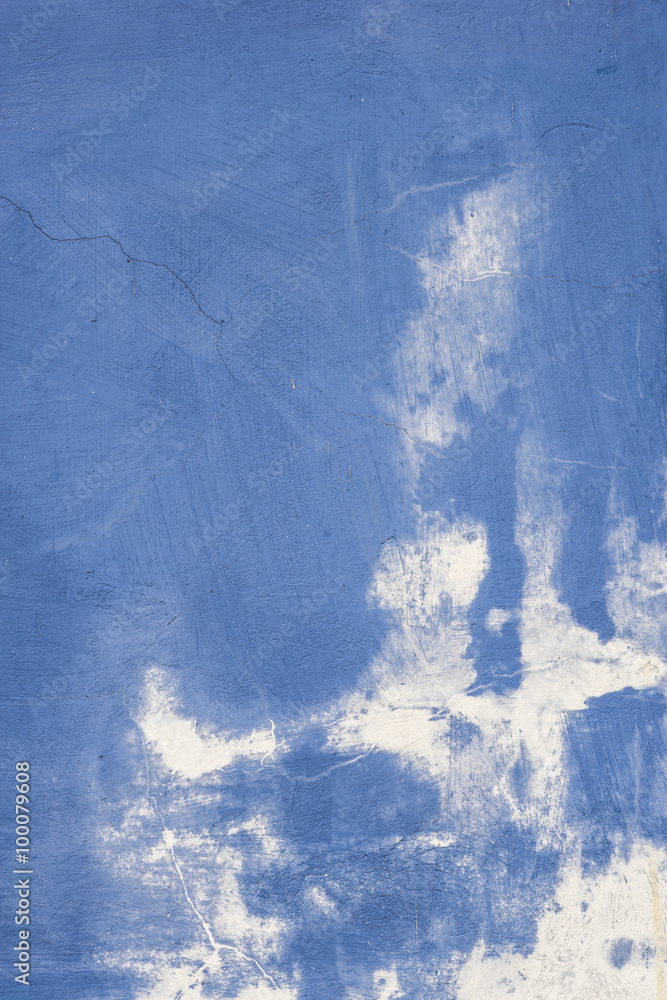 Fototapeta premium Blue and white painted cracking wall texture background.