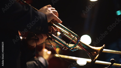 Two men playing on trumpets on the stage 1 photo