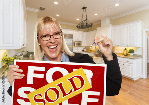 Young Woman Holding Sold Si...