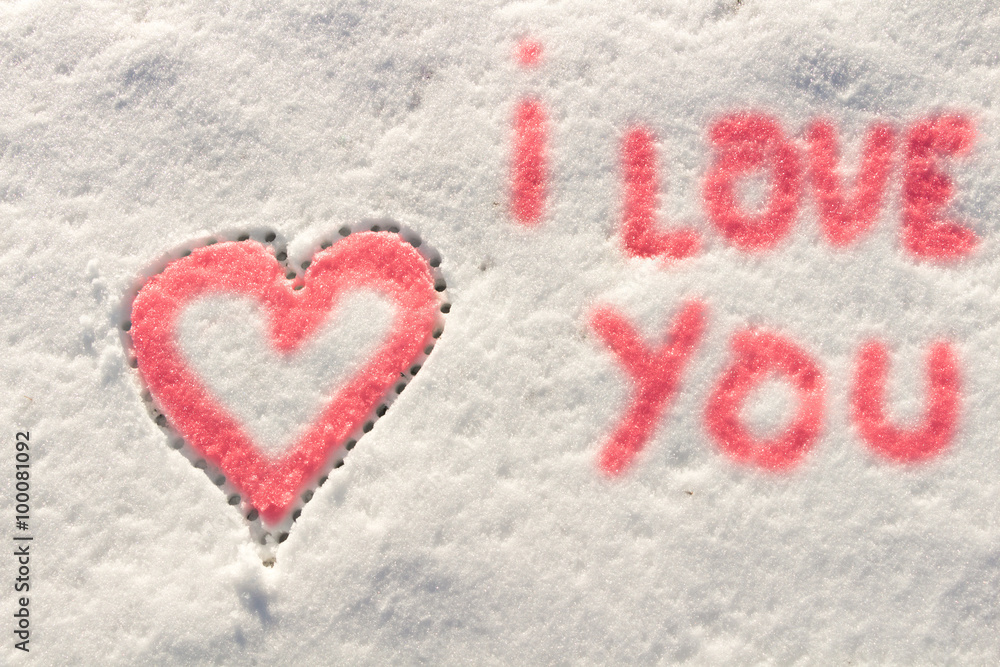 I love you with heart sign writing on the snow. 