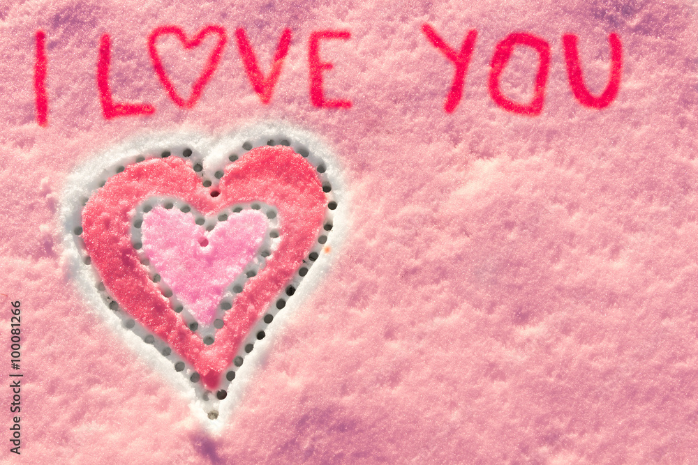 I love you with heart sign writing on the snow. 