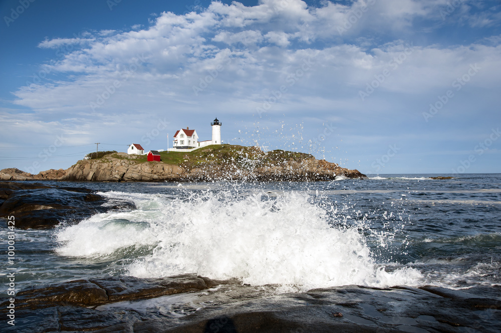 Waves Crashing on Rocks by Lighthouse in Maine