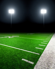 Football field illuminated by stadium lights