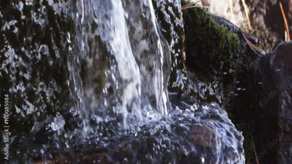 Closeup slow motion water fall splashing as it hits rock. Closeup slow motion water fall splashing as it hits rock.