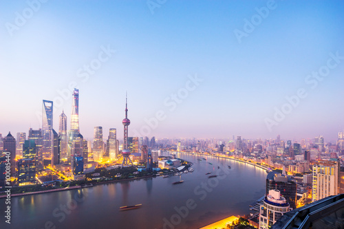 waterfront cityscape and illuminated skyline at dawn