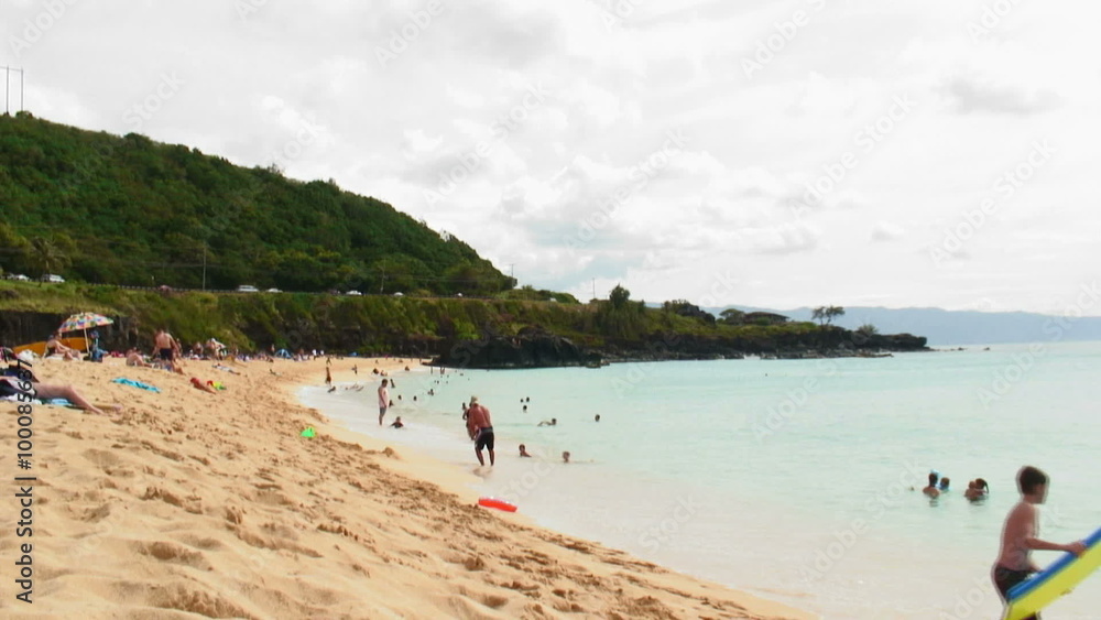 Beach in Hawaii with people swimming and relaxing. Beach in Hawaii with people swimming and relaxing.