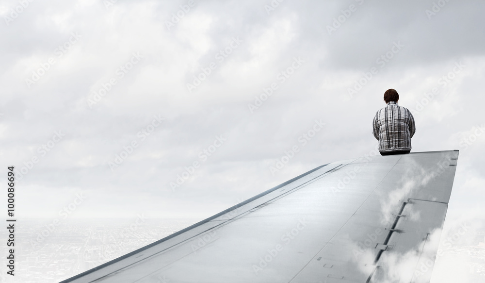 Obraz premium Woman on airplane wing