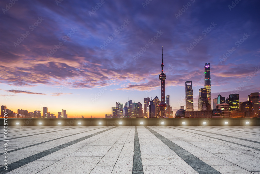 empty floor and cityscape in colorful sky at dawn