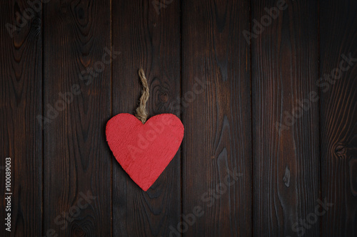 Wooden heart on dark wood background