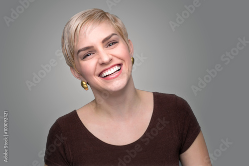 Photography Adorable laughing lady head shot short pixie haircut modern style gray backgroun